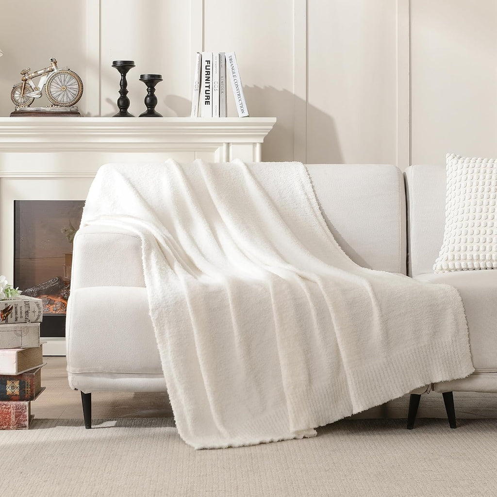 Cream knit throw blanket on a couch